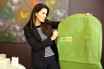 Woman holding a Green Garmento bag.